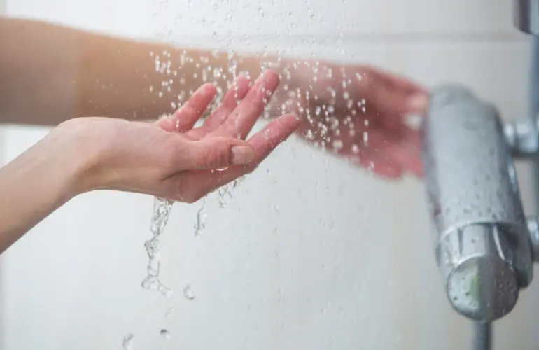 Hands under water running from a tap