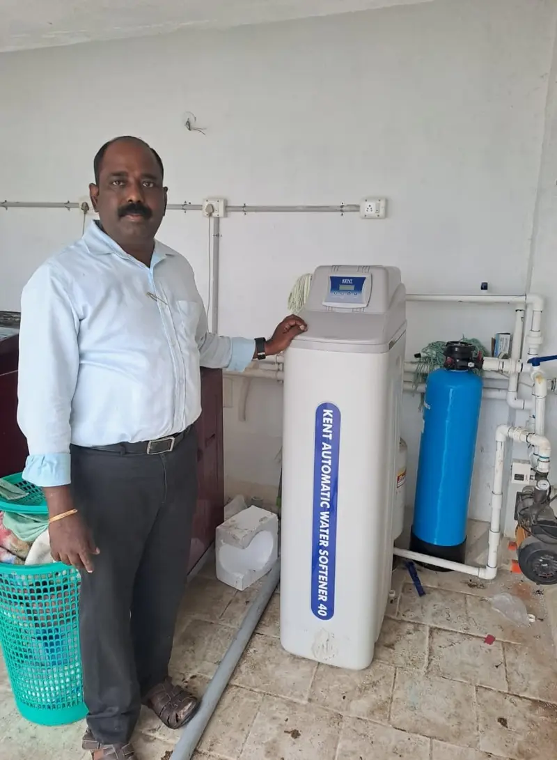 Cabinet-style water softener and blue filter installed by Evergreen Aqua