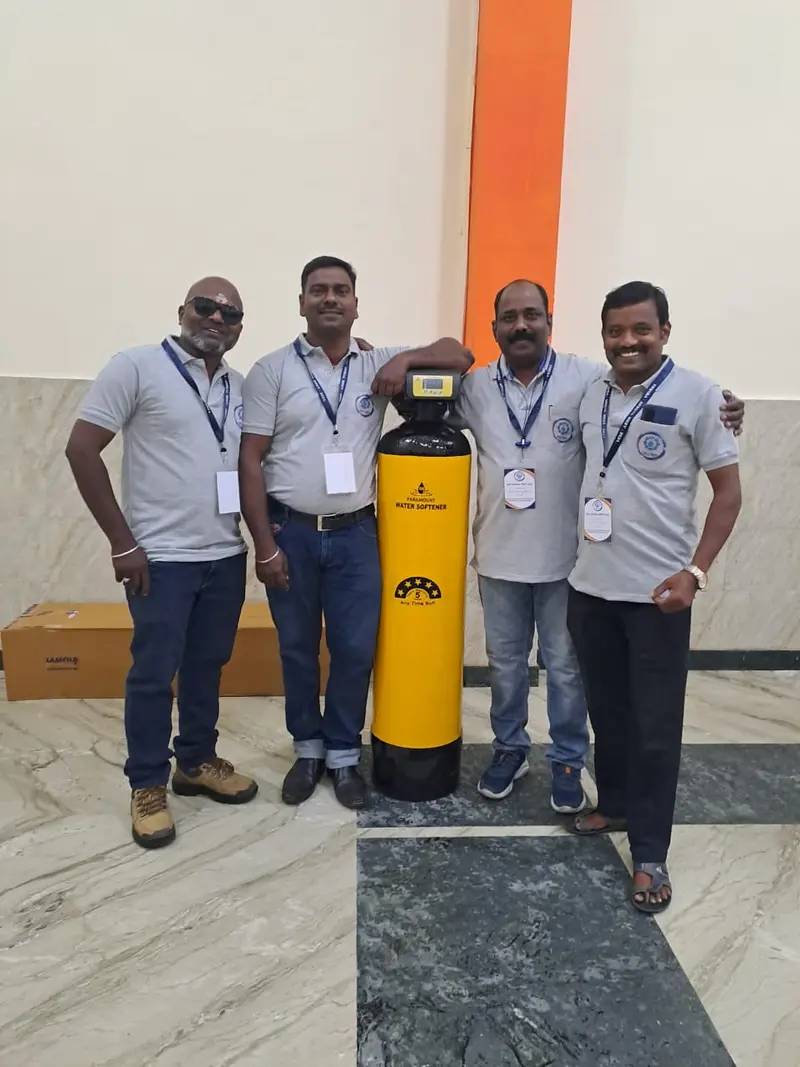 Evergreen Aqua team beside a newly installed water softener