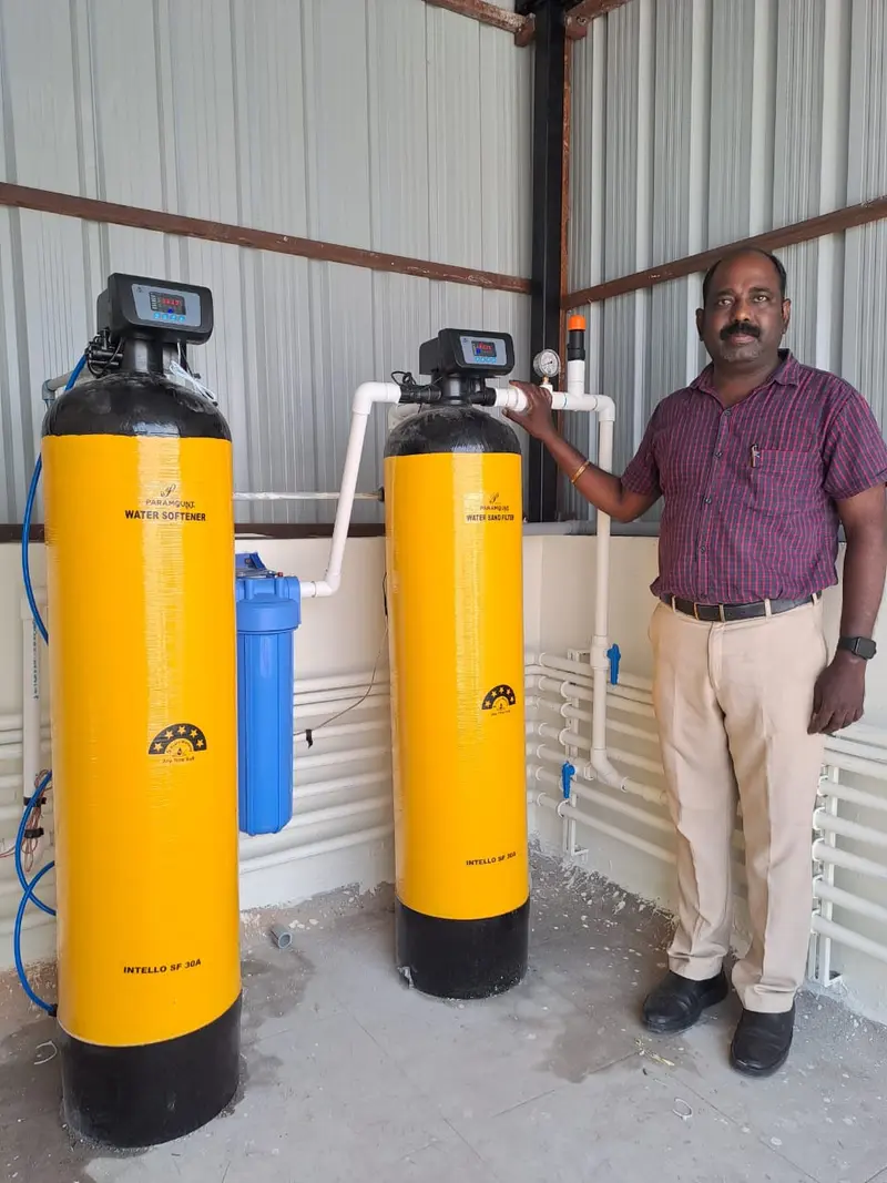 Evergreen Aqua technician beside a twin-vessel installation